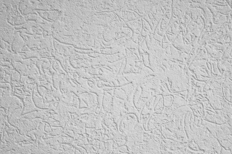 Close-up van een muur met krabpleisterstructuur