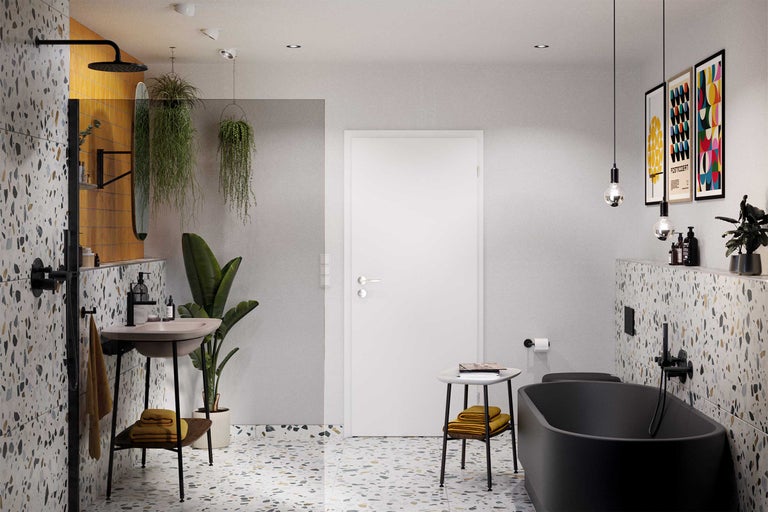 Badkamer met wastafel, bad, deur en terrazzo vloer