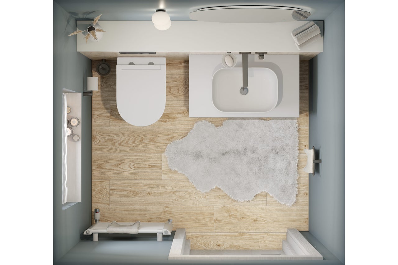 Bovenaanzicht van een moderne badkamer met wit toilet, wastafel, lichte vloer in houtlook en een zacht wit tapijt.