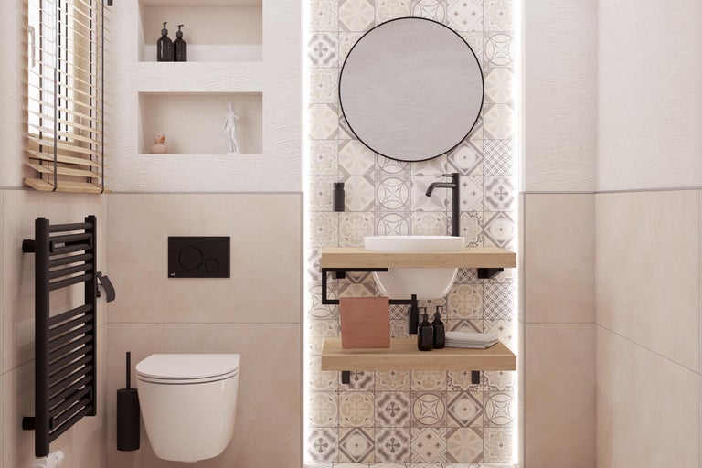 Lichte badkamer met toilet, wastafel, spiegel en radiator