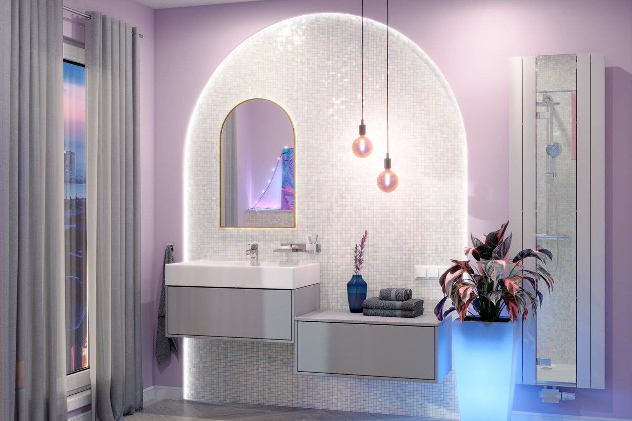 Badkamer met wastafel, spiegel, handdoeken, decoratie en verlichting