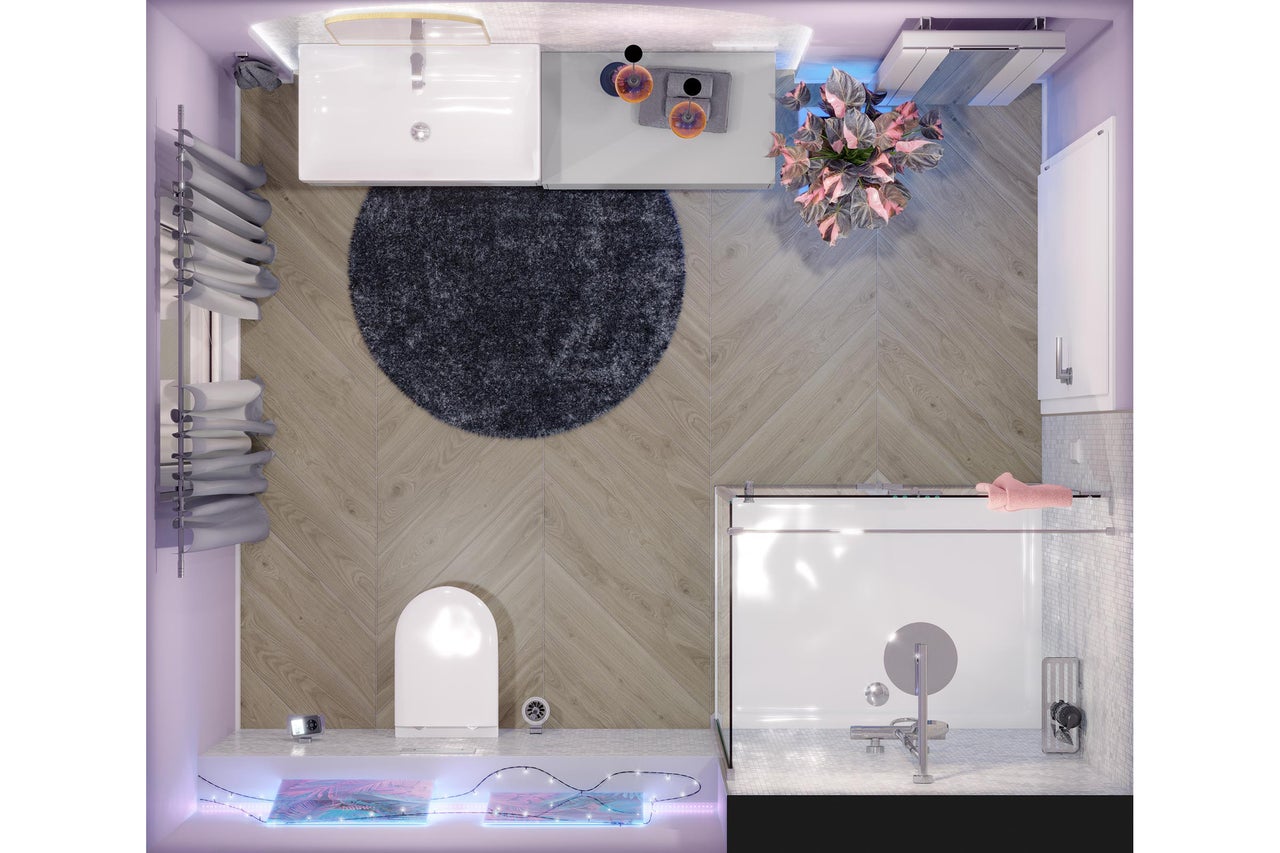 Bovenaanzicht van een moderne badkamer met houtlook vloertegels in visgraatmotief, witte wastafel, toilet, glazen douche en rond tapijt.