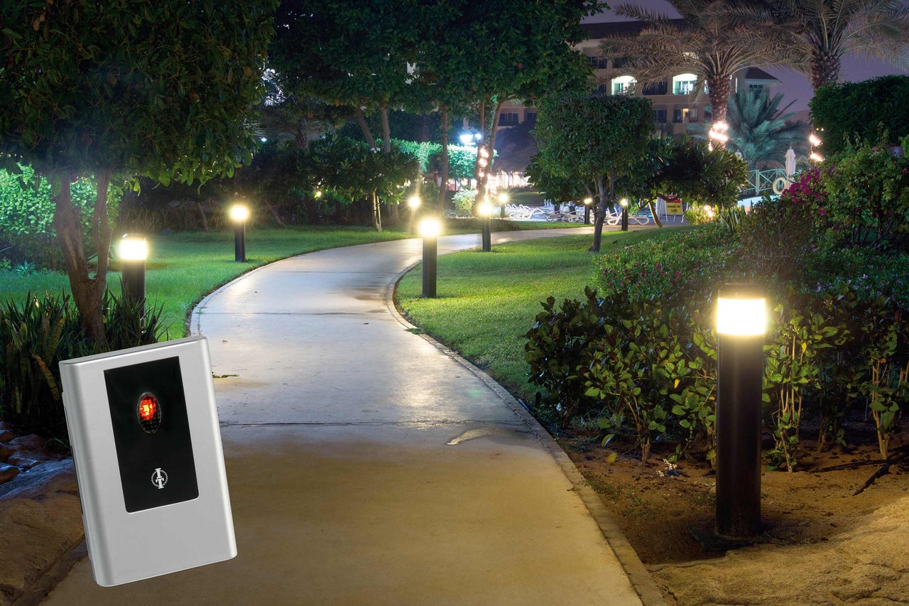 Parklandschap bij nacht met wandelpaden en verlichting, plus een zilverkleurig apparaat