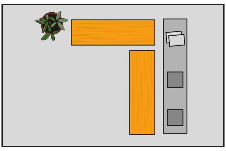 Bovenaanzicht van een hoekbureau met plant, bureaubladen en rolcontainer