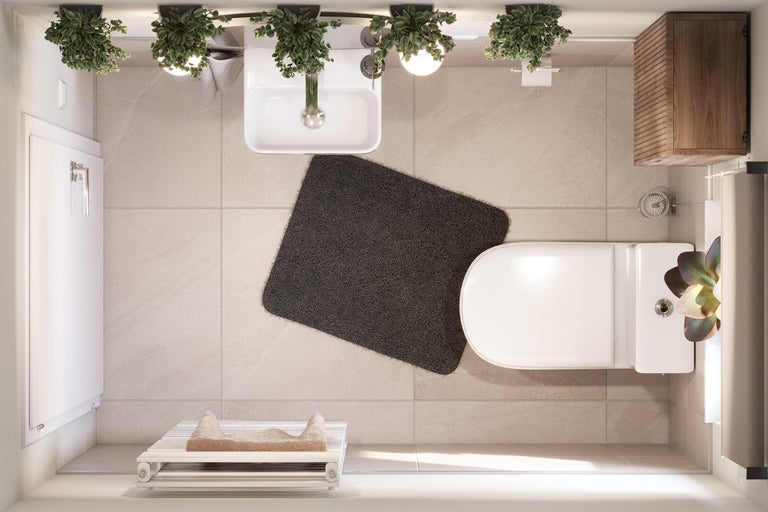 Bovenaanzicht van een lichte badkamer met toilet, wastafel, badmat en handdoekradiator