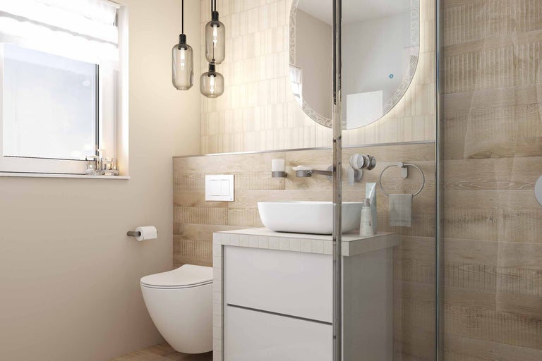 Badkamer met toilet, wastafel, spiegel en verlichting