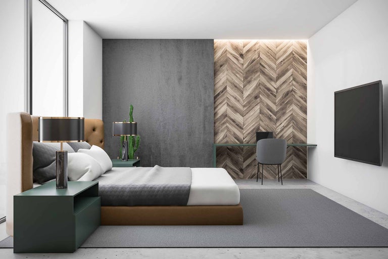 Slaapkamer met bed, bureau en televisie aan de muur