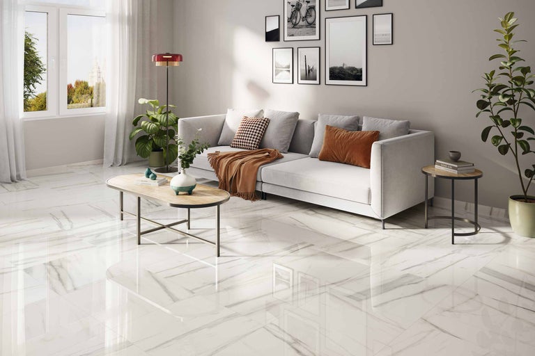 Lichte woonkamer met bank, salontafel en vloertegels in marmerlook