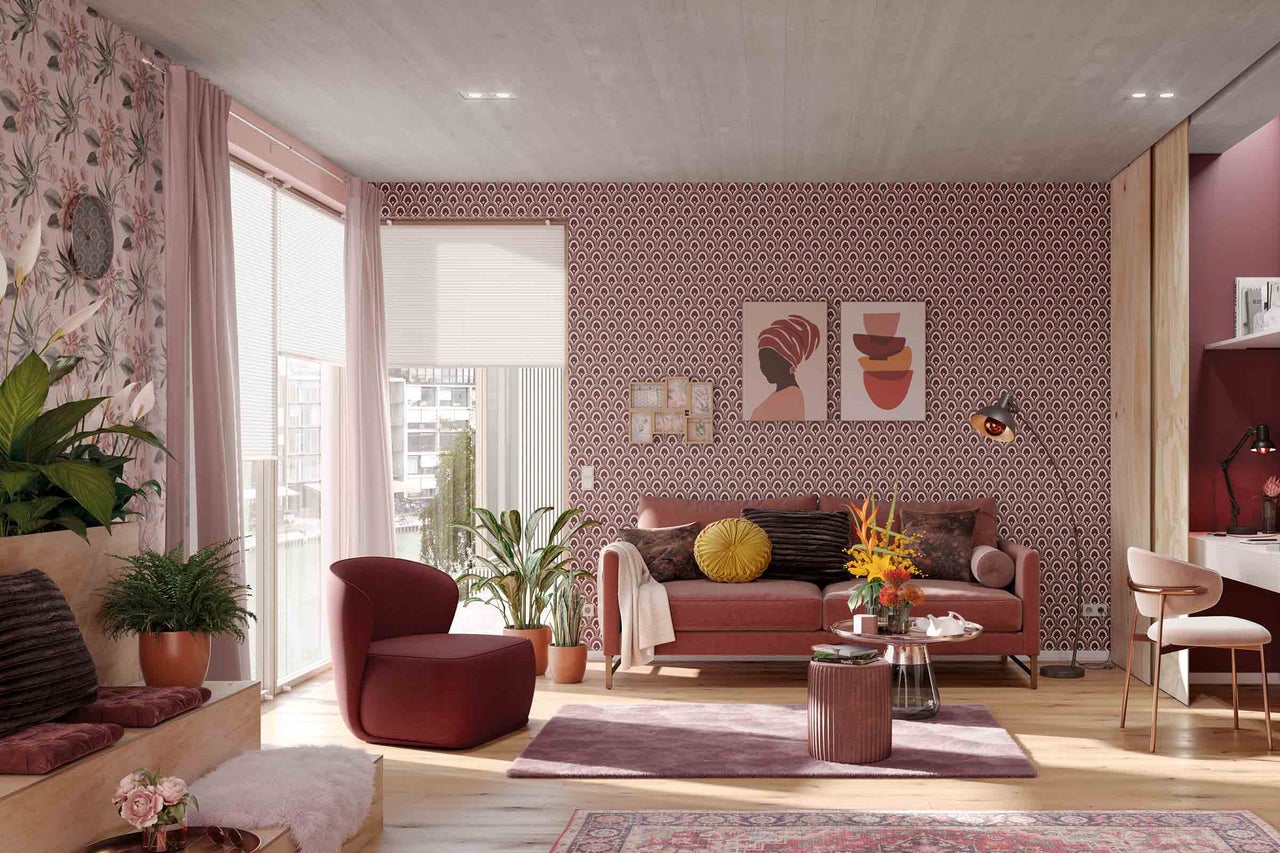 Woonkamer met bank, fauteuil, kamerplanten en decoratieve wandbekleding voor een stijlvolle sfeer.