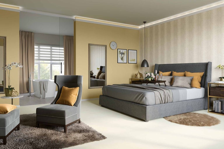 Lichte slaapkamer met grijze meubels, bed, fauteuil en bad