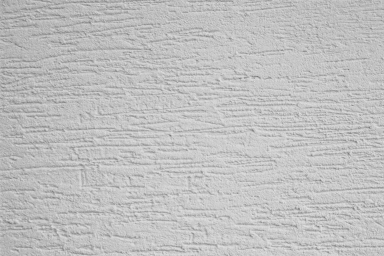 Close-up van een muur met krabpleisterstructuur