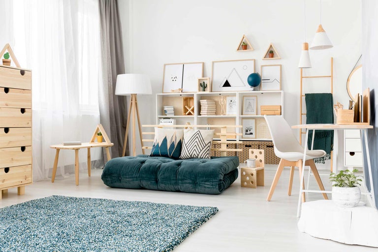 Lichte woonkamer met blauwgroene matras, planken en houten elementen