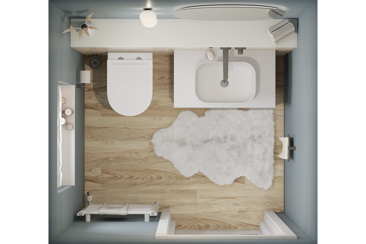 Bovenaanzicht van een badkamer met toilet, wastafel, bad en badmat