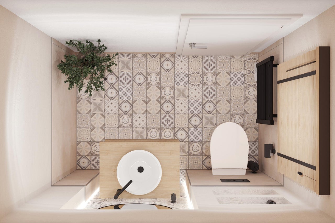 Badkamer met toilet, wastafel, tegels en radiator