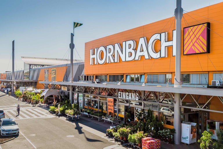 Buitenaanzicht van een Hornbach bouwmarkt met entree en parkeerplaats
