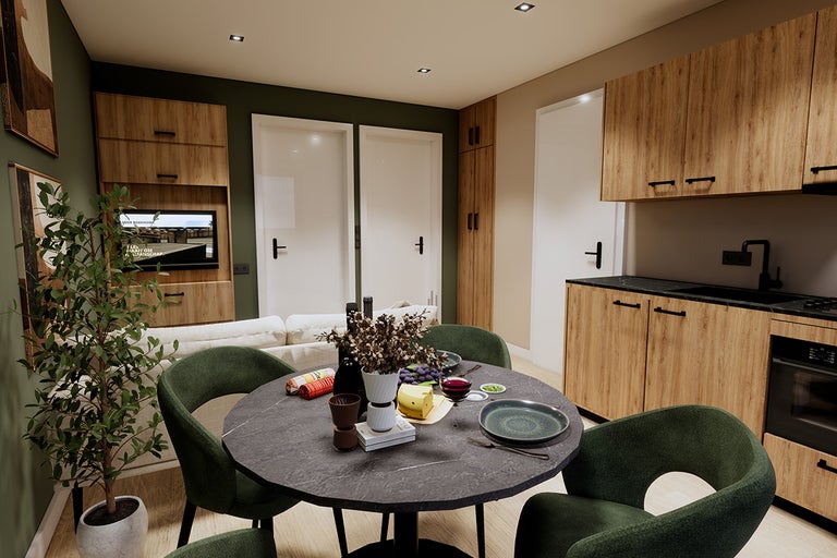 Eetkamer met eettafel, stoelen en kitchenette in een moderne woonkamer.