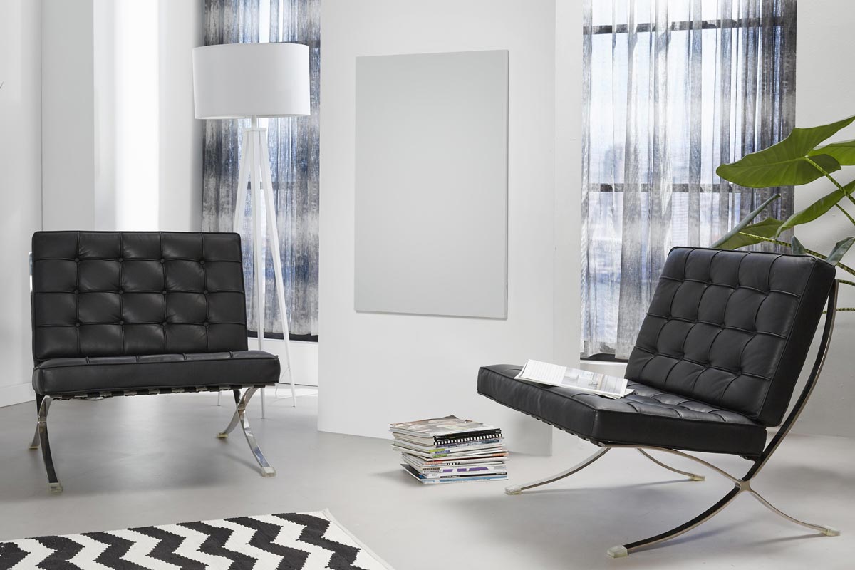 Woonkamer met twee fauteuils, een staande lamp en een radiator