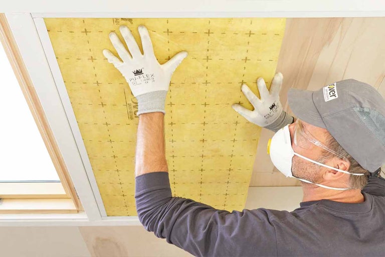 Man brengt thermische isolatie aan op het plafond