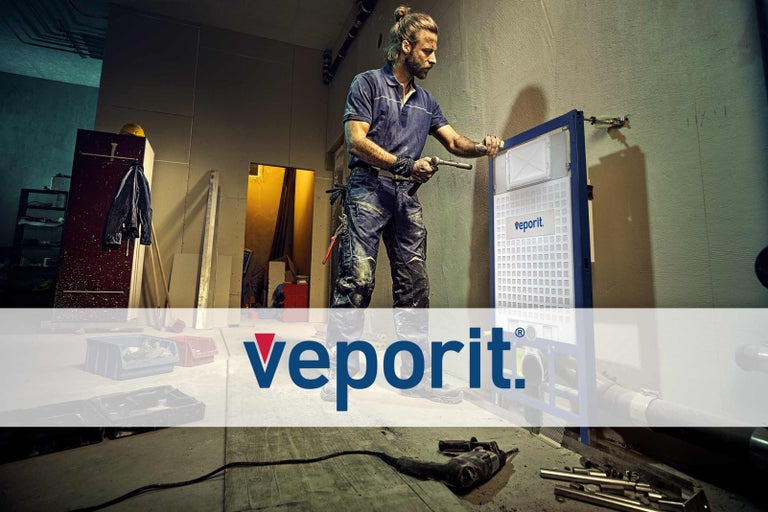 Een vakman installeert een Veporit inbouwreservoir voor een ruwe muur.