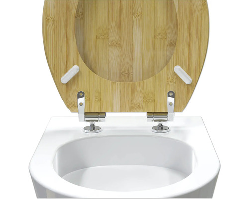 Toiletdeksel van bamboe op een wit toilet