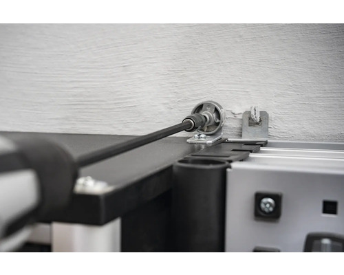 Detailopname van een garagedeuraandrijving met boormachine.
