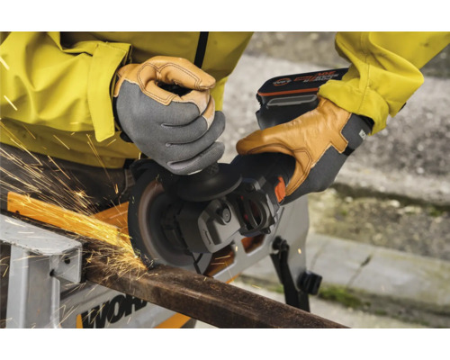 Iemand gebruikt een draadloze haakse slijper om metaal te snijden, waarbij vonken ontstaan.
