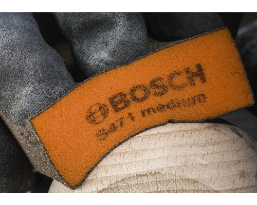 Bosch schuurpad medium op hout met handschoen