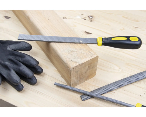 Houtrasp met stuk hout en werkhandschoen