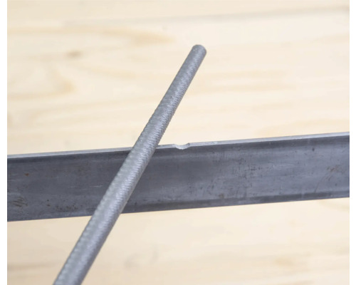 Ronde vijl in gebruik op een stuk metaal