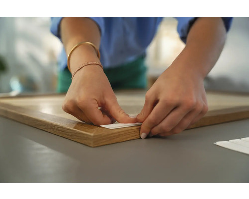 Aanbrengen van een zelfklevende ophanghaak op een houten frame