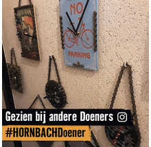 Decoratieve klokken gemaakt van fietsonderdelen aan een muur