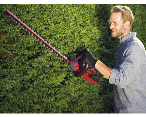 Man snoeit heg met een heggenschaar