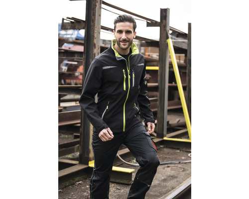 Man draagt een softshell jack en een werkbroek