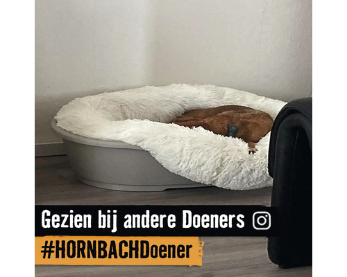 Hond slaapt in een hondenbed met imitatiebont
