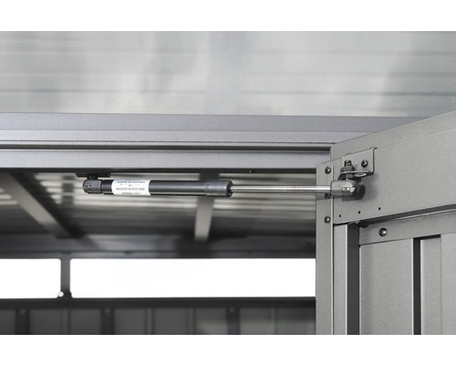 Detailopname van een gasdrukveer op een tuinhuisdeur