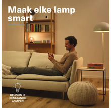 Man zit op een bank in een woonkamer met verlichting