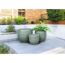 Drie keramische plantenbakken op een terras