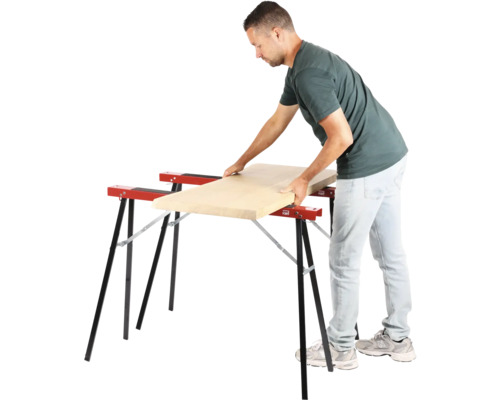 Man legt houten plank op twee schragen