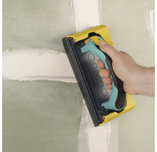 Handschuurmachine gebruikt voor het schuren van een muur.