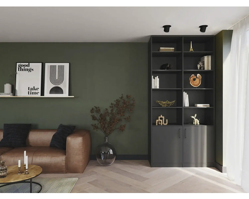 Woonkamer met leren bank, boekenkast en decoraties voor een stijlvolle sfeer