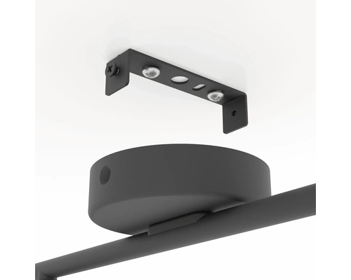 Detailopname van een zwart plafondlamp met bevestigingsmateriaal