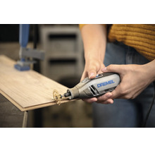 Dremel 4250 multitool met doorslijpschijf snijdt in een houten plank.