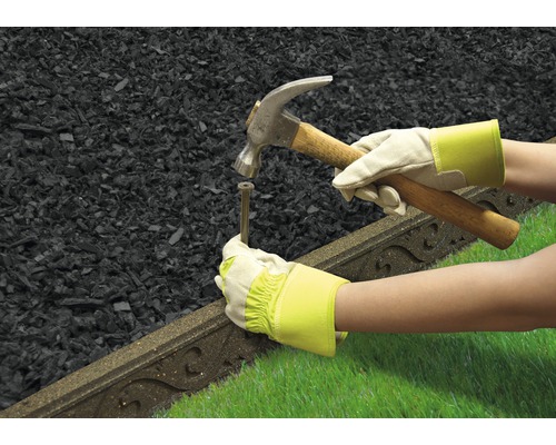 Tuinlandschap met gazonrand, hamer en persoon