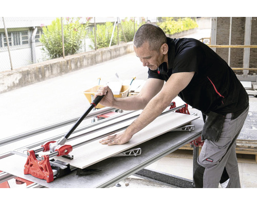 Tegelsnijder in gebruik bij het snijden van een tegel