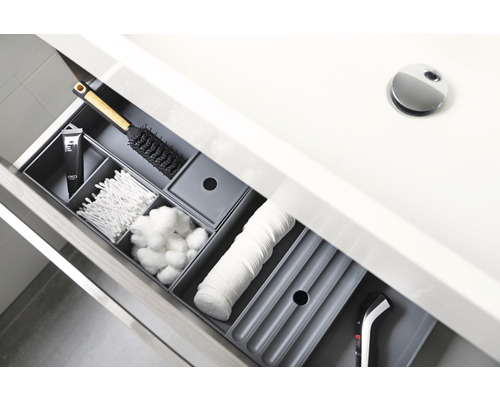 Lade met badkamerartikelen zoals wattenstaafjes, wattenbollen, scheerapparaat en haarborstel