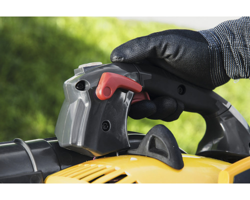 Bediening van een gele bladzuiger met handschoenen