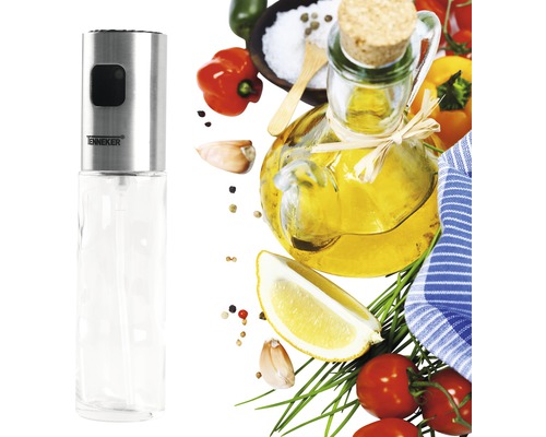 Oliespuit van roestvrij staal en glas met diverse ingrediënten op de achtergrond