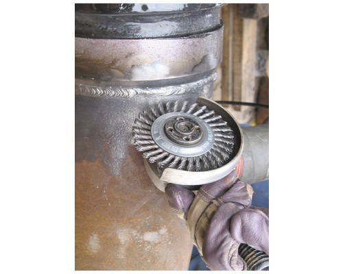 Draadborstel in gebruik op een metalen pijpverbinding