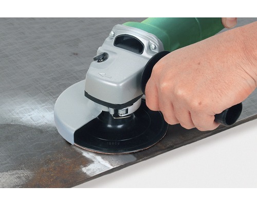 Een persoon schuurt metaal met een haakse slijper.