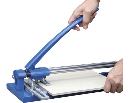 Tegelsnijder in gebruik voor het snijden van een tegel